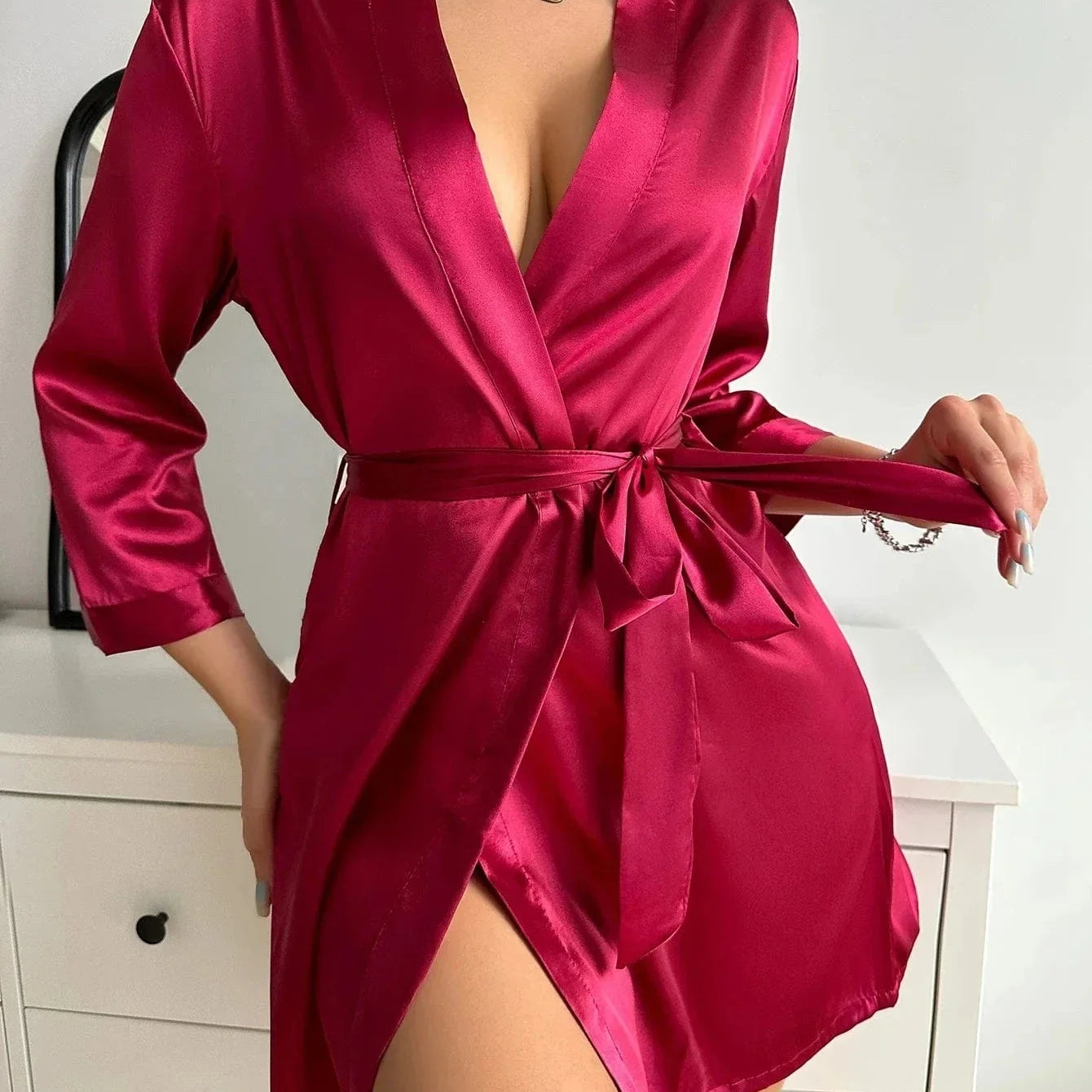 Kimono satin rouge pour femme, modèle, avec une coupe élégante et fluide. Ce kimono à manches longues et ceinture à la taille offre un confort optimal et un style raffiné, parfait pour une soirée chic ou un moment de détente.