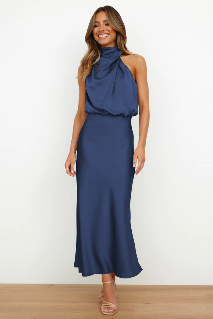 Cette robe longue de couleur bleu nuit présente un col drapé et une silhouette fluide, idéale pour des occasions élégantes en été. Son tissu satin offre une allure chic et confortable.