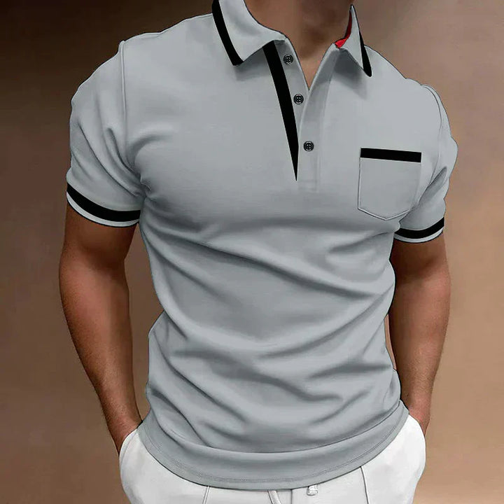 Ce polo gris pour homme allie confort et style avec ses finitions noires au col et aux manches. La poche sur la poitrine ajoute une touche de praticité et d&