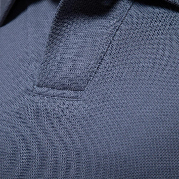 Détail du col du polo bleu, mettant en valeur la coupe soignée et la texture du tissu. Un design élégant et raffiné, parfait pour un look intemporel et moderne.