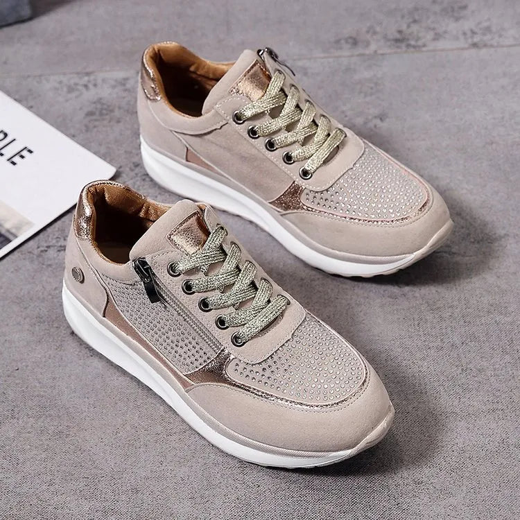 Optez pour ces baskets élégantes et confortables pour femme, alliant cuir suédé beige et détails métalliques dorés. Avec des perforations sur le dessus pour un style moderne et une fermeture éclair latérale pour un ajustement pratique. Parfaites pour un look décontracté et tendance tout en garantissant un confort au quotidien.