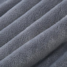 Gros plan sur la texture du pyjama en flanelle pour homme, montrant un tissu gris très doux, épais et moelleux. Matière chaude et confortable, idéale pour l’hiver.