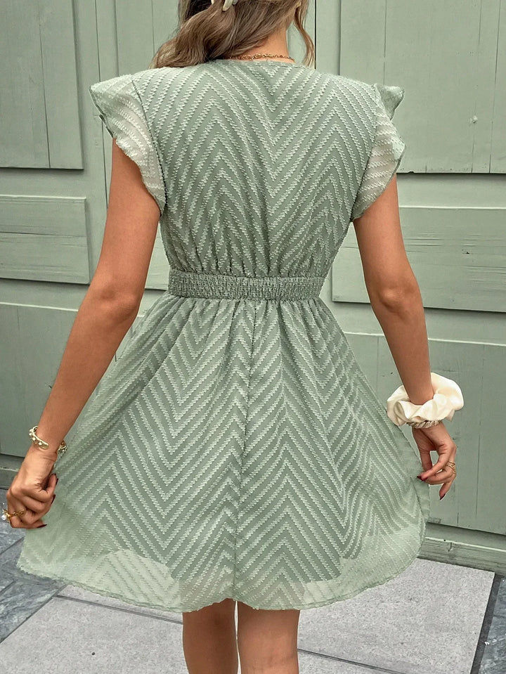 Robe mini d’été pour femme vert pastel, légère et confortable, vue arrière avec coupe fluide et taille élastique, idéale pour un look estival frais et féminin.