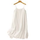 nuisette blanche fluide à fines bretelles, coupe ample avec volant froncé en bas, suspendue sur cintre.