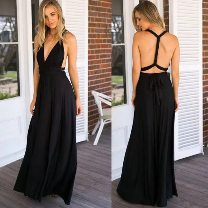 Robe longue noire élégante, avec un décolleté plongeant et un dos nu croisé, apportant une touche moderne et séduisante. Son tissu fluide et sa coupe flatteuse assurent un confort optimal tout en mettant en valeur la silhouette. Idéale pour les soirées et événements formels, cette robe combine raffinement et simplicité.