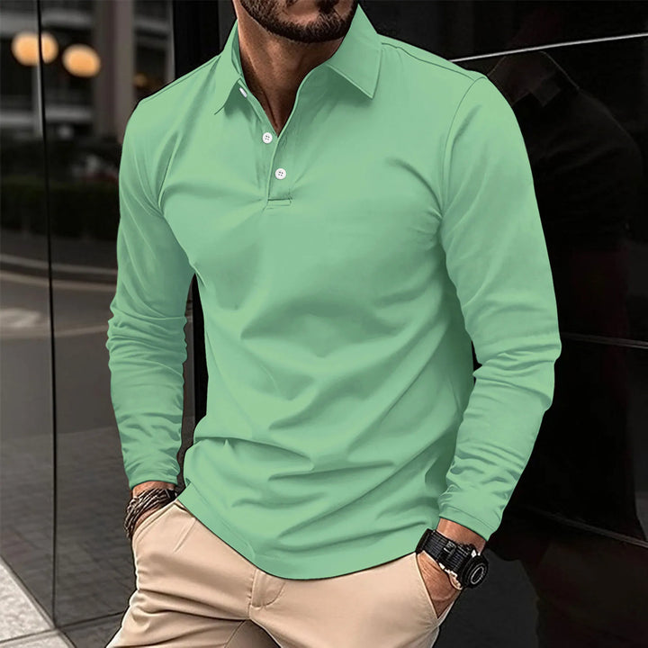 Polo à manches longues de couleur vert menthe, avec un col classique et des boutons blancs. Ce modèle combine confort et élégance, idéal pour un look décontracté et polyvalent, à porter pour diverses occasions.