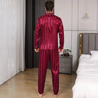 Vue de dos d’un homme portant le pyjama satin pour homme Philippe, ensemble léger et raffiné en satin bordeaux à fines rayures, composé d’une chemise à manches longues et d’un pantalon assorti, mettant en valeur la coupe élégante et la fluidité du tissu pour un confort optimal.