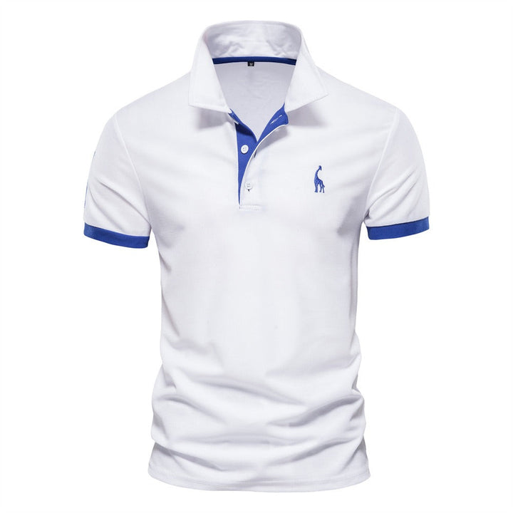 Un polo pour homme de couleur blanche avec des détails bleus sur le col et les manches. Le polo est orné du logo de girafe sur la poitrine. Idéal pour une tenue estivale décontractée, il offre confort et style tout en restant frais et moderne.