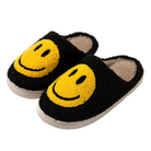 Chaussons unisexe Sasha noirs en tissu doux avec grand motif smiley jaune, intérieur chaud et moelleux, semelle confortable, parfaits pour un style cosy à la maison.